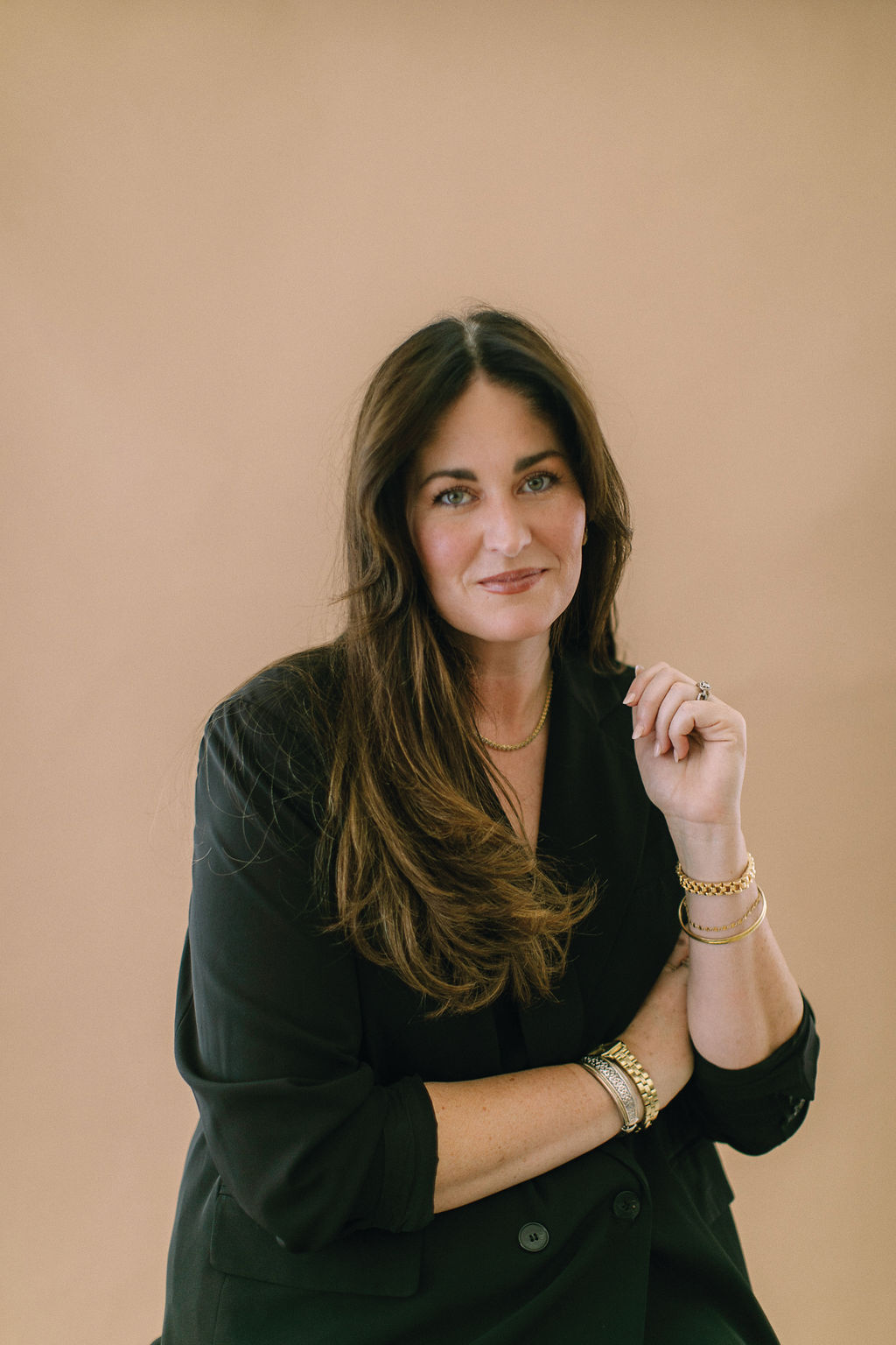Lindsay Davidson in a tailored black blazer and gold jewelry